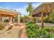 Tropical backyard featuring a charming tiki hut and lush greenery surrounding a relaxing spa at 6405 Break Point Ave, Las Vegas, NV 89130