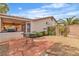 The backyard features a patio, built-in BBQ, desert landscaping and perimeter block wall at 6405 Break Point Ave, Las Vegas, NV 89130