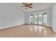 Bright bedroom with tile floors, ceiling fan, and double doors leading to the backyard at 6405 Break Point Ave, Las Vegas, NV 89130