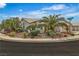 Charming single-story home on a corner lot features lush landscaping with mature palm trees at 6405 Break Point Ave, Las Vegas, NV 89130