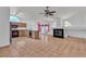 Open-concept kitchen with breakfast bar, modern appliances, and a view of the fireplace at 6405 Break Point Ave, Las Vegas, NV 89130
