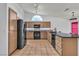 Modern kitchen with black appliances, spacious countertops, and a large window for natural light at 6405 Break Point Ave, Las Vegas, NV 89130