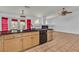 Contemporary kitchen island features a breakfast bar, dishwasher and view of the adjacent fireplace and living area at 6405 Break Point Ave, Las Vegas, NV 89130
