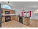 Kitchen with black appliances, granite countertops, and window with natural light above the sink at 6405 Break Point Ave, Las Vegas, NV 89130