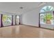 Bright and airy living room featuring tile flooring, arched windows, and neutral paint at 6405 Break Point Ave, Las Vegas, NV 89130