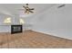 Spacious living room showcasing a modern fireplace, tiled floors, and ample natural light at 6405 Break Point Ave, Las Vegas, NV 89130