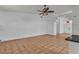Open living room features neutral tile floors and a ceiling fan, creating a welcoming space at 6405 Break Point Ave, Las Vegas, NV 89130