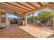 Spacious outdoor patio with tile flooring, ceiling fan, built-in grill, and cozy seating area at 6405 Break Point Ave, Las Vegas, NV 89130