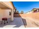Spacious backyard with a concrete patio, a barbecue grill, and a gravel area, ready for outdoor enjoyment at 6476 Little Harbor Ct, Las Vegas, NV 89141