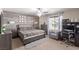 Bedroom suite with a bed, a desk, a decorative wood wall, and a soft rug at 6476 Little Harbor Ct, Las Vegas, NV 89141
