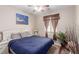 Comfortable bedroom featuring a large bed, a ceiling fan, and natural light from the window at 6476 Little Harbor Ct, Las Vegas, NV 89141