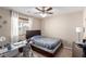 Bright bedroom featuring natural light from a window and a modern glass-top desk for a workspace at 6476 Little Harbor Ct, Las Vegas, NV 89141