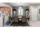 Well-lit dining room with tile flooring and open concept, complete with decor and a modern chandelier at 6476 Little Harbor Ct, Las Vegas, NV 89141
