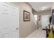 Well-lit hallway featuring tile flooring, complemented by neutral walls and a stairway to the upper level at 6476 Little Harbor Ct, Las Vegas, NV 89141