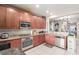 Well-lit kitchen with granite countertops, stainless steel appliances, and ample wood cabinetry at 6476 Little Harbor Ct, Las Vegas, NV 89141