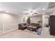 Spacious living room area with comfortable leather sofas, ceiling fan, and plenty of room to relax at 6476 Little Harbor Ct, Las Vegas, NV 89141