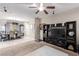 Inviting living room featuring tile and carpet flooring, complemented by natural light and an open concept layout at 6476 Little Harbor Ct, Las Vegas, NV 89141