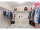 Organized walk-in closet featuring built-in shelving, hanging rods, and a central dresser for ample storage space at 6476 Little Harbor Ct, Las Vegas, NV 89141
