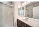 Modern bathroom features a glass enclosed shower, a double vanity with marble countertop and updated lighting at 6484 Mount Eden Ave, Las Vegas, NV 89139