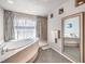 This spacious bathroom boasts a soaking tub with tile surround and large mirror at 6484 Mount Eden Ave, Las Vegas, NV 89139