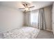 Bedroom with a ceiling fan, natural light, and patterned carpet at 6484 Mount Eden Ave, Las Vegas, NV 89139
