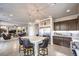 Open kitchen with a large center island, stainless steel appliances, and seamless flow to the living area at 6484 Mount Eden Ave, Las Vegas, NV 89139