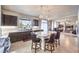 Open concept kitchen with a spacious island, dark cabinetry and stainless appliances flows seamlessly into the living room at 6484 Mount Eden Ave, Las Vegas, NV 89139