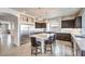 Bright kitchen features a large island with bar seating, stainless steel appliances, and dark wood cabinets at 6484 Mount Eden Ave, Las Vegas, NV 89139