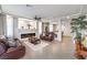 Bright living room with a fireplace, tile floors, and stylish leather furniture at 6484 Mount Eden Ave, Las Vegas, NV 89139