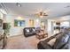 Bright living room with open layout, ceiling fan, and leather furniture set at 6484 Mount Eden Ave, Las Vegas, NV 89139