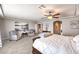 This primary bedroom features neutral walls, ceiling fan, sitting area, and en suite bath entrance at 6484 Mount Eden Ave, Las Vegas, NV 89139