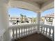 Balcony view showcasing neighborhood homes, lush palm trees, and clear blue skies at 6625 Gossamer Fog Ave, Las Vegas, NV 89139