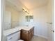 Bright bathroom featuring an extended vanity with a white countertop and wooden cabinets at 6625 Gossamer Fog Ave, Las Vegas, NV 89139