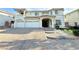 Elegant two-story home featuring a three-car garage and a spacious driveway with professional landscaping at 6625 Gossamer Fog Ave, Las Vegas, NV 89139