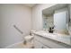 The bathroom has a vanity with granite counters and a framed mirror at 6649 W Tropicana Ave # 101, Las Vegas, NV 89103