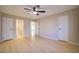 This bedroom offers a view of a hallway, multiple doors, and light-colored wood floors at 6649 W Tropicana Ave # 101, Las Vegas, NV 89103