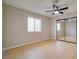 Bright bedroom featuring hardwood floors, a ceiling fan, and mirrored closet doors at 6649 W Tropicana Ave # 101, Las Vegas, NV 89103