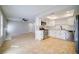 Modern kitchen with stainless steel appliances and white cabinets open to living area at 6649 W Tropicana Ave # 101, Las Vegas, NV 89103
