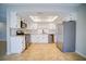 Spacious kitchen featuring white cabinets, stainless steel appliances, and modern tile flooring at 6649 W Tropicana Ave # 101, Las Vegas, NV 89103