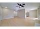 Spacious living room featuring ceiling fan, wood floors, and access to kitchen area at 6649 W Tropicana Ave # 101, Las Vegas, NV 89103