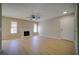 Cozy living room enhanced by natural light, a traditional fireplace, and sleek wood-style flooring at 6649 W Tropicana Ave # 101, Las Vegas, NV 89103