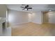 Spacious living area featuring wood-style floors, neutral walls, and a classic white-brick fireplace at 6649 W Tropicana Ave # 101, Las Vegas, NV 89103