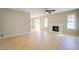 Bright living room with fireplace, ceiling fan, and wood-style flooring, offering a welcoming space at 6649 W Tropicana Ave # 101, Las Vegas, NV 89103
