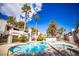 The community has a shared pool and hot tub surrounded by palm trees and landscaping at 6649 W Tropicana Ave # 101, Las Vegas, NV 89103