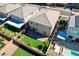 Aerial view of the backyard with a patio, lawn, and neighboring homes, showcasing the property's layout and surroundings at 6790 Tangled Vines Ave, Las Vegas, NV 89139