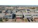 Neighborhood aerial view showing a two-story home with a tile roof, red garage door, and desert landscaping at 6790 Tangled Vines Ave, Las Vegas, NV 89139