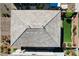 Aerial view of a roof with interspersed shades of grey tiles with grass yard and landscaping to the side at 6790 Tangled Vines Ave, Las Vegas, NV 89139