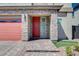 Charming front entrance with brick-paved walkway, stone accents, and a bright red front door at 6790 Tangled Vines Ave, Las Vegas, NV 89139