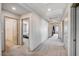 Hallway with access to multiple rooms and neutral decor at 6790 Tangled Vines Ave, Las Vegas, NV 89139