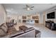 Open living space with wood floors, modern furnishings, and seamless access to the kitchen and dining area at 6790 Tangled Vines Ave, Las Vegas, NV 89139